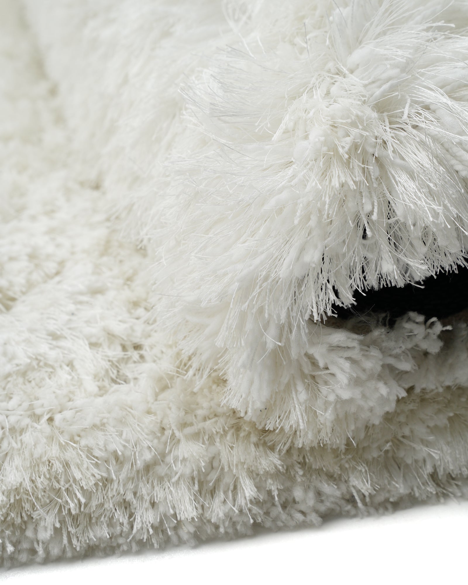 Folded View Ivory Organic Shape Shaggy Hand-Tufted Polyester Rug