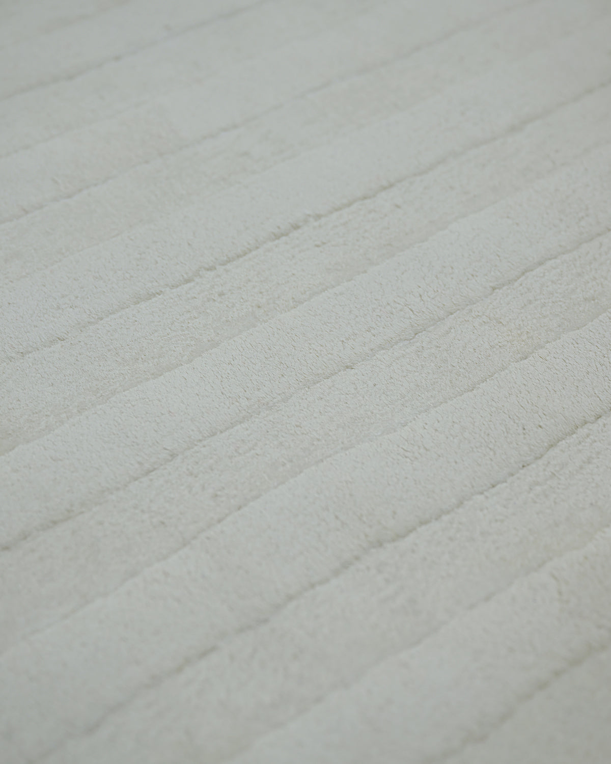 Ivory white carved Meander high-low bamboo silk rug texture close-up